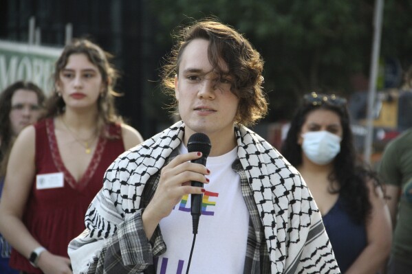 Nathaniel Dibble, a member of the Young Democratic Socialists of America at North Carolina State University, voices opposition to repealing North Carolina's public university system's diversity policy before the UNC Board of Governors' vote outside of the UNC system office in Raleigh, N.C., on Thursday, May 23, 2024. About 35 protesters from schools across the university system gathered in the demonstration. (AP Photo/Makiya Seminera)
