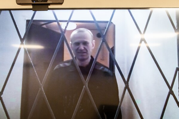 Russian opposition leader Alexei Navalny is seen on a TV screen as he appears in a video link provided by the Russian Federal Penitentiary Service from the courtroom in Kovrov, Vladimir region, about 240 kilometers (150 miles) east of Moscow, Russia, Wednesday, Jan. 10, 2024. Navalny, 47, is jailed on charges of extremism. He had been imprisoned in the Vladimir region of central Russia, but was transferred last month to a "special regime" penal colony — the highest security level of prisons in Russia — above the Artic Circle. His allies decried the transfer to a colony in the town of Kharp, in the Yamalo-Nenets region about 1,900 kilometers (1,200 miles) northeast of Moscow, as yet another attempt to force Navalny into silence. (AP Photo/Antonina Favorskaya)