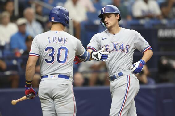 Texas Rangers' Corey Seager, right, celebrates with teammate Nathaniel Lowe (30) after hitting a home run against the Tampa Bay Rays during the fith inning of a baseball game, Sunday, Sept. 18, 2022, in St. Petersburg, Fla. (AP Photo/Mark LoMoglio)