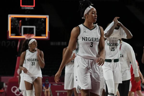 FILE - Nigeria players walk off the court after their loss in the women's basketball preliminary round game against Japan at the 2020 Summer Olympics, Aug. 2, 2021, in Saitama, Japan. FIBA-Nigeria, basketball's world governing body, confirmed Thursday, June 2, 2022, that Nigeria has withdrawn its team from the women's World Cup and warned of "potential disciplinary measures" against the country because of government interference. Nigeria's government announced last month that it was withdrawing all its basketball teams from international competitions for two years while it completely restructures the sport. (AP Photo/Eric Gay, File)