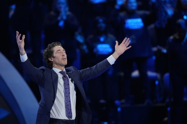Pastor Joel Osteen prays during a service at Lakewood Church Sunday, Feb. 18, 2024, in Houston. Osteen welcomed worshippers back to Lakewood Church for the first time since a woman with an AR-style opened fire in between services at his Texas megachurch last Sunday. (APPhoto/David J. Phillip)