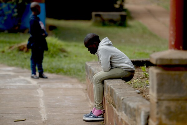 A child sits outside a classroom at the Nyumbani Children's Home in Nairobi, Kenya Tuesday, Aug. 15, 2023. The orphanage, which is heavily reliant on foreign donations, cares for over 100 children with HIV whose parents died of the disease and provides them with housing, care, and PEPFAR supplied anti-retroviral drugs. A U.S. foreign aid program that officials say has saved 25 million lives in Africa and elsewhere is being threatened by some Republicans who fear program funding might go to organizations that promote abortion. (AP Photo/Brian Inganga)