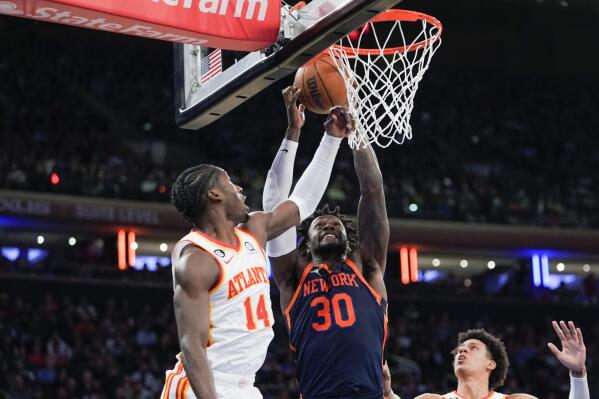 New York Knicks forward Julius Randle (30) and Atlanta Hawks forward AJ Griffin (14) vie for a rebound during the first half of an NBA basketball game Wednesday, Dec. 7, 2022, at Madison Square Garden in New York. (AP Photo/Mary Altaffer)