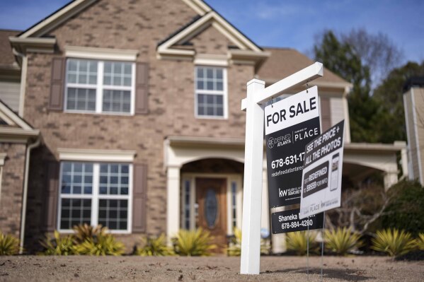 FILE - A for sale is displayed outside a home, Feb. 1, 2024, in Aceworth, Ga. Georgia lawmakers said on Tuesday, March, 19, that the state House and Senate may be close to a deal to limit increases in the taxable values of homes, dampening property tax increases. (AP Photo/Mike Stewart, File)