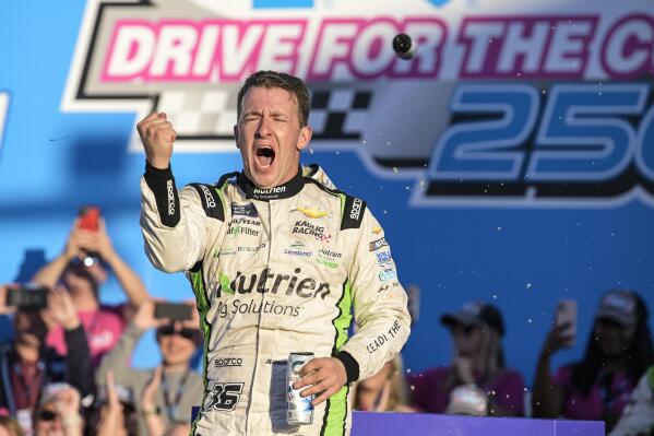 AJ Allmendinger celebrates in Victory Lane after winning the NASCAR Xfinity auto race at Charlotte Motor Speedway on Saturday, Oct. 8, 2022, in Concord, N.C. (AP Photo/Matt Kelley)