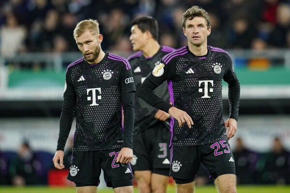 Bayern Munich's Konrad Laimer, Min-jae Kim and Thomas Mueller stands on the pitch in the team's German Cup soccer match against Saarbruecken on Wednesday, Nov. 1, 2023, in Saarbruecken, Germany. (Uwe Anspach/dpa via AP)