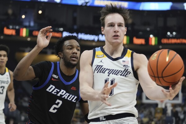 Marquette's Tyler Kolek drives past DePaul's Chico Carter Jr. during the first half of an NCAA college basketball game Wednesday, Feb. 21, 2024, in Milwaukee. (AP Photo/Morry Gash)