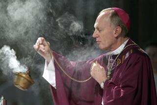 FILE - Bishop Howard Hubbard swings incense during an Ash Wednesday communion service at the Cathedral of the Immaculate Conception on Feb. 25, 2004, in Albany, N.Y. Hubbard, now retired and who has admitted to covering up for predator priests and has himself been accused of sexual abuse, has asked Pope Francis to laicize him, or remove him from the priesthood. Hubbard, 84, announced the decision in a statement Friday, Nov. 18, 2022, the day the United Nations has designated as the World Day for Previous of Child Sexual Abuse and Exploitation. (AP Photo/Jim McKnight, File)