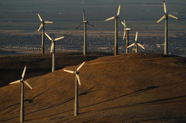 File - Wind turbines operate in Livermore, Calif., on Wednesday, Aug. 10, 2022. Across Europe companies are weighing up the U.S. Inflation Reduction Act's $375 billion in benefits for renewable industries against the European Union's fragmented response. (AP Photo/Godofredo A. Vásquez, File)