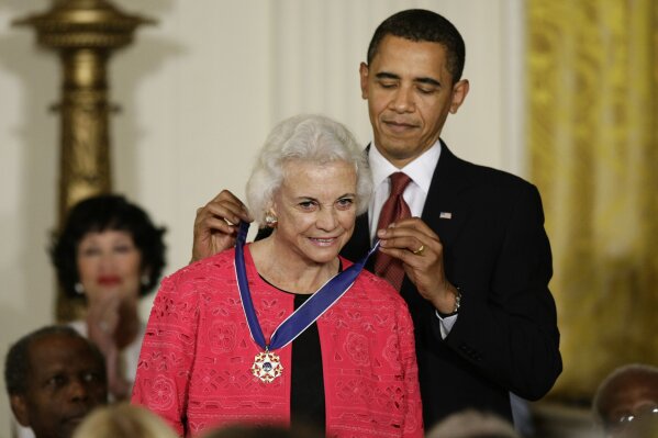 
              FILE - In this Aug. 12, 2009 file photo, President Barack Obama presents the 2009 Presidential Medal of Freedom to Sandra Day O'Connor.  O'Connor, the first woman on the Supreme Court, announced Tuesday that she has the beginning stages of dementia, “probably Alzheimer’s disease.”   (AP Photo/J. Scott Applewhite)
            