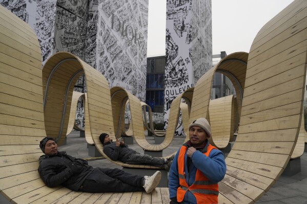Young workers rest outside a shopping mall in Beijing, Wednesday, Jan. 17, 2024. China published youth unemployment data Wednesday for the first time since the jobless rate hit a record high in June last year, using a new method that showed an apparent improvement. (AP Photo/Ng Han Guan)