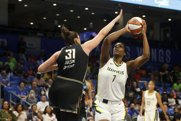 Dallas Wings center Teaira McCowan (7) shoots as she is defended by New York Liberty center Stefanie Dolson (31) during the first half of a WNBA basketball game in Arlington, Texas, Monday, Aug. 8, 2022. (Michael Ainsworth/The Dallas Morning News via AP)