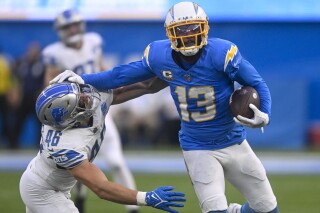 FILE - Los Angeles Chargers wide receiver Keenan Allen (13) rushes past Detroit Lions linebacker Jack Campbell (46) during an NFL football game Sunday, November 12, 2023, in Inglewood, Calif. The Chicago Bears are acquiring wide receiver Keenan Allen from the Los Angeles Chargers for a fourth-round pick, people informed of the decision told The Associated Press on Thursday, March 14, 2024. (AP Photo/Denis Poroy, File)