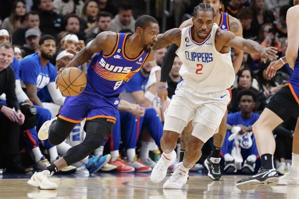 Phoenix Suns' Terrence Ross (8) drives around Los Angeles Clippers' Kawhi Leonard (2) during the first half of an NBA basketball game Thursday, Feb. 16, 2023, in Phoenix. (AP Photo/Darryl Webb)