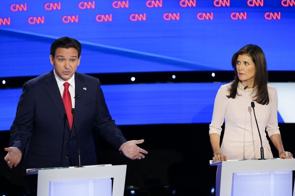 Former UN Ambassador Nikki Haley, right, looks over towards Florida Gov. Ron DeSantis, left, during the CNN Republican presidential debate at Drake University in Des Moines, Iowa, Wednesday, Jan. 10, 2024. (AP Photo/Andrew Harnik)