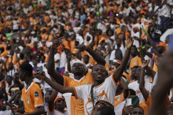 Ivory Coast supporters wait for their team to arrive at the Felix Houphouet Boigny Stadium in Abidjan, Ivory Coast, Monday, Feb. 12, 2024, one day after they defeated Nigeria and won the 2024 African Cup of Nations. (AP Photo/Themba Hadebe)