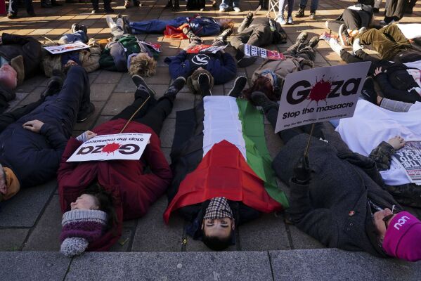 People take part in a die-in ahead of a Scottish Palestinian Solidarity Campaign demonstration in Glasgow, Scotland, Saturday, Nov. 11, 2023. (Jane Barlow/PA via AP)
