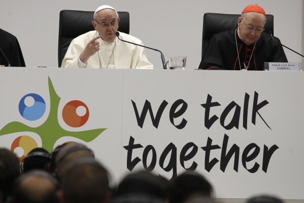 Pope Francis, left, flanked by Cardinal Kevin Farrell, delivers a speech at the Mater Ecclesiae college in Rome, March 19, 2018. (AP Photo/Alessandra Tarantino, File)