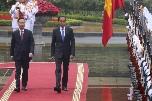 Vietnamese President Vo Van Thuong, left, and Indonesian President Joko Widodo inspect honor guards in Hanoi, Vietnam on Friday, Jan. 12, 2024. Widodo is on a three-day visit to Hanoi to boost the bilateral relation with the fellow Southeast Asian nation. (AP Photo/Huy Han)