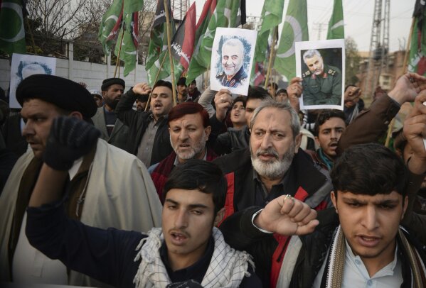 Pakistani demonstrate over the U.S. airstrike in Iraq that killed Iranian Revolutionary Guard Gen. Qassem Soleimani, in Peshawar, Pakistan, Friday, Jan. 3, 2020. Iran has vowed "harsh retaliation" for the U.S. airstrike near Baghdad's airport that killed Tehran's top general and the architect of its interventions across the Middle East, as tensions soared in the wake of the targeted killing. (AP Photo/Muhammad Sajjad)