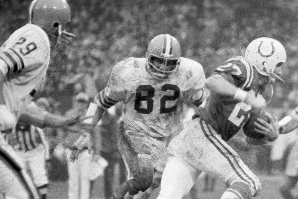 FILE - In this Dec. 26, 1971, file photo, Cleveland Browns linebacker Jim Houston (82) chases after Baltimore Colts wide receiver Ray Perkins during a  football game in Cleveland. Houston's widow would keep notes on her husband's deteriorating condition in a three-ring binder so she would be prepared for the day when he needed full-time care. (AP Photo/FIle)