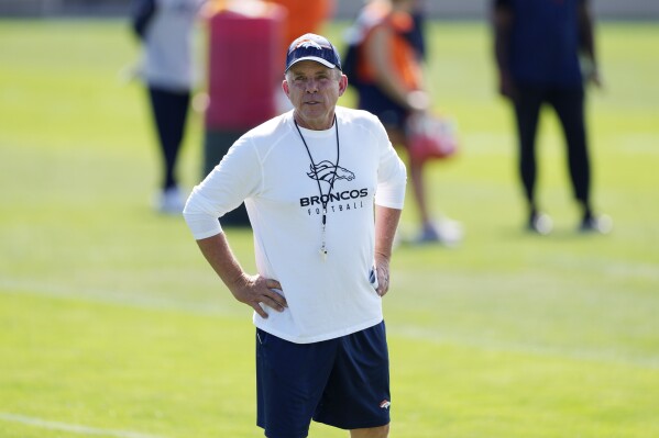 Denver Broncos head coach Sean Payton looks on as players take part in drills during an NFL football training camp Thursday, July 27, 2023, in Centennial, Colo. (AP Photo/David Zalubowski)