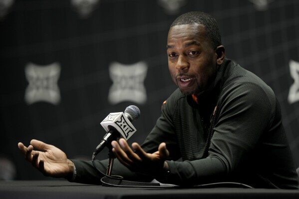 Oklahoma State coach Mike Boynton addresses the media during the NCAA college Big 12 men's basketball media day Wednesday, Oct. 18, 2023, in Kansas City, Mo. (AP Photo/Charlie Riedel)