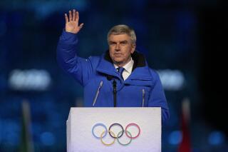 International Olympic Committee President Thomas Bach waves during the closing ceremony of the 2022 Winter Olympics, Sunday, Feb. 20, 2022, in Beijing. (AP Photo/Jae C. Hong)