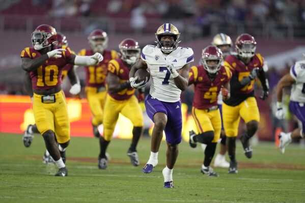 Washington running back Dillon Johnson (7) runs for a touchdown during the first half of an NCAA college football game against Southern California Saturday, Nov. 4, 2023, in Los Angeles. (AP Photo/Marcio Jose Sanchez)