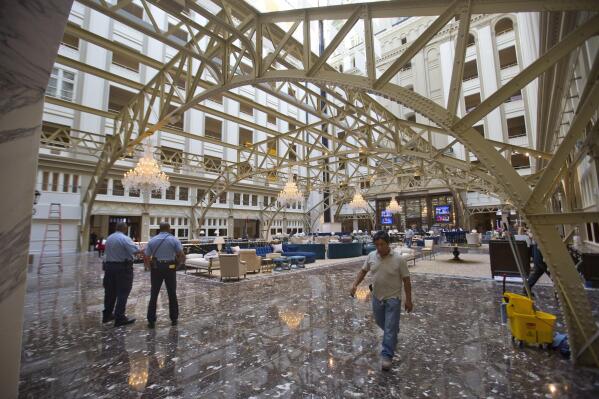 FILE - In this Sept. 12, 2016 file photo, the main lobby of the Trump International Hotel in downtown Washington. Trump's $200 million hotel inside the federally owned Old Post Office building has become the place to see, be seen, drink, network, even live, for the still-emerging Trump set. It's a rich environment for lobbyists and anyone hoping to rub elbows with Trump-related politicos, despite the veil of ethics questions that hangs overhead.   (AP Photo/Pablo Martinez Monsivais, File)