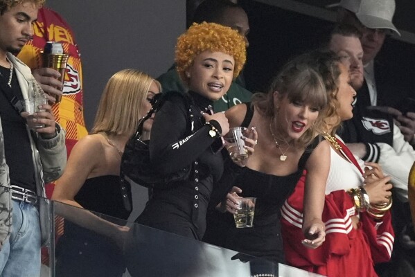 Ice Spice, left, and Taylor Swift talk before the NFL Super Bowl 58 football game between the San Francisco 49ers and the Kansas City Chiefs, Sunday, Feb. 11, 2024, in Las Vegas. (AP Photo/George Walker IV)