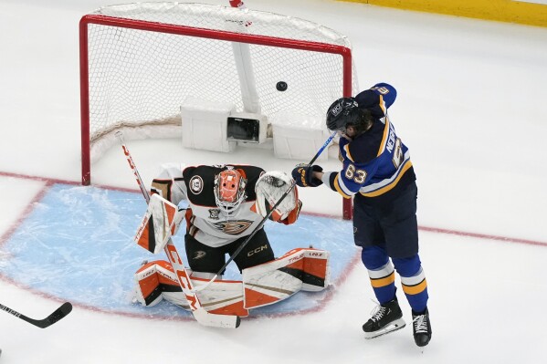 St. Louis Blues' Jake Neighbours (63) scores past Anaheim Ducks goaltender Lukas Dostal during the third period of an NHL hockey game Sunday, March 17, 2024, in St. Louis. (AP Photo/Jeff Roberson)