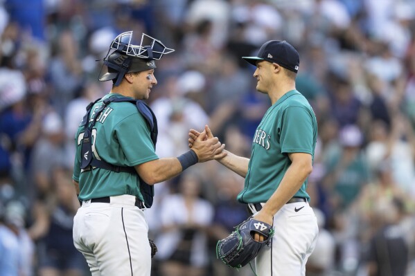 Cal Raleigh of the Seattle Mariners is congratulated by teammates