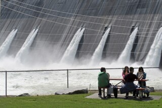 FILE - Water is released through the outlet tubes at Grand Coulee Dam, Wash., on the Columbia River on June 1, 2011. The Biden administration on Thursday, Sept. 21, 2023, has pledged over $200 million toward reintroducing salmon in the Upper Columbia River Basin in an agreement with tribes that includes a stay on litigation for 20 years. (AP Photo/Nicholas K. Geranios, File)