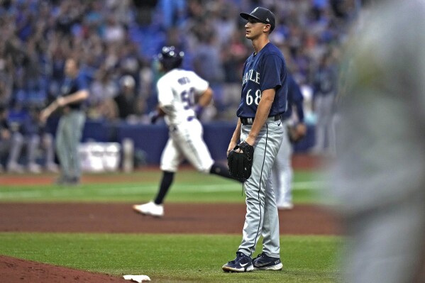 Seattle Mariners starting pitcher George Kirby (68) reacts as Tampa Bay Rays' Rene Pinto (50) runs around the bases after his two-run home run during the seventh inning of a baseball game Friday, Sept. 8, 2023, in St. Petersburg, Fla. (AP Photo/Chris O'Meara)