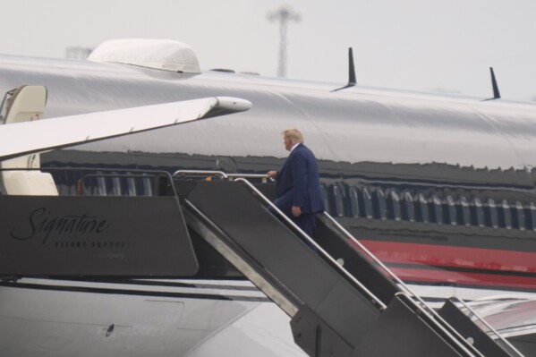 Former President Donald Trump boards his plane at Newark Liberty International Airport in Newark, N.J., Thursday, Aug. 3, 2023. Donald Trump headed to Washington on Thursday to answer to charges that he worked to overturn the 2020 presidential election, with the former president set to appear in a federal courthouse mere blocks from the U.S. Capitol building that his supporters stormed to try to block the peaceful transfer of power. (AP Photo/Seth Wenig)