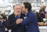 Actor Edgar Ramirez, right, kisses fellow actor Robert De Niro during a photo call for "Hands of Stone" at the 69th international film festival, Cannes, southern France on May 16, 2016. (AP Photo/Joel Ryan, File)