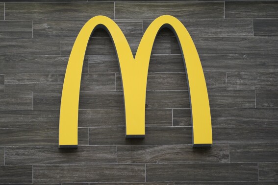 FILE - A McDonald's logo hangs outside of a location in Havertown, Pa., on April 26, 2022. A McDonald's franchise that controls 12 restaurants in metro New Orleans violated child labor laws affecting more than 70 minors, the U.S. Department of Labor said Tuesday, July 25, 2023. The division also found similar violations at four McDonald's locations operated in Texas. (AP Photo/Matt Rourke, File)
