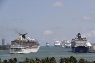 FILE - Cruise ships float at PortMiami, on April 7, 2020, in Miami. The trade group representing the cruise ship industry unsuccessfully pushed international authorities to water down new environmental regulations despite members' commitments to addressing climate change, ocean air pollution experts have warned. (AP Photo/Lynne Sladky, File)