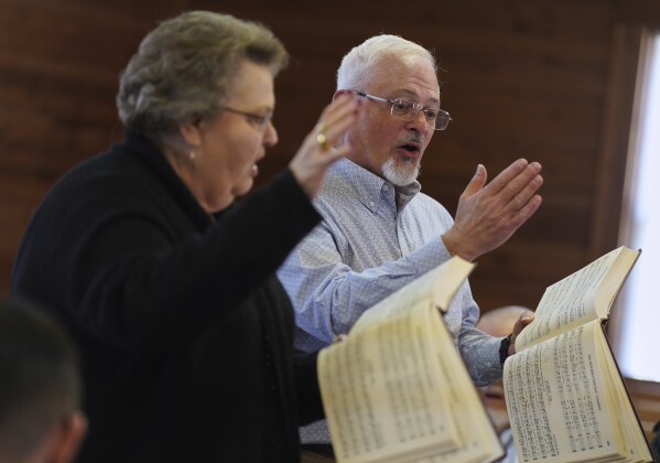 Sacred Harp singers lead from the hollow square, a special formation in which singers, organize into four voice parts and face each other to create an open center, at Holly Springs Primitive Baptist Church in Bremen, Ga., on Saturday, March 22, 2025. (AP Photo/Jessie Wardarski)