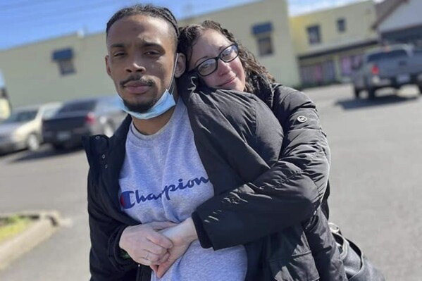 This photo released by the Clark family's legal representatives, shows Derrick Clark Jr., left, with his mother Sarah Miles in Portland, Or. Police officers in Oregon shot and killed Clark Jr., a 24-year-old Black man, in the back and then instead of providing medical care, mocked his lifeless body, threw explosives at him and sent a dog to attack his corpse, his family alleges in an updated lawsuit filed Thursday with additional details from the 2022 shooting. (Courtesy of the Clark family via AP)