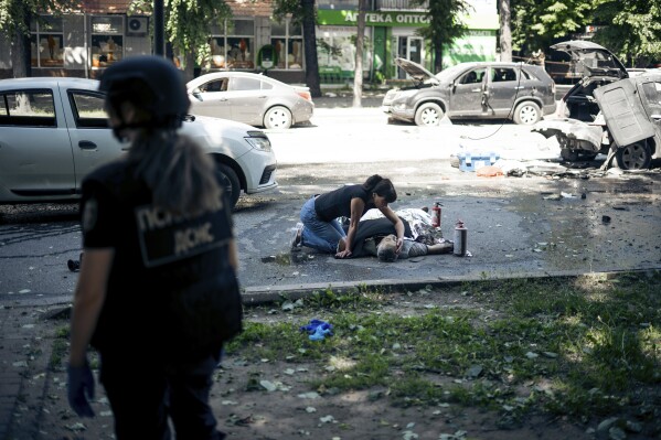 A woman touches the body of a relative killed in a Russian strike on Sumy, Ukraine, on Tuesday, June 3, 2025. (AP Photo/Yehor Kryvoruchko, Kordon Media)