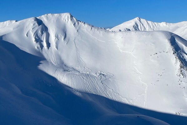 This Sunday, March 23, 2025, image released by the Chugach National Forest Avalanche Center shows the aftermath of a slab avalanche that killed a snow machine rider on Saturday, March 22, in Turnagain Pass, Alaska. (Chugach National Forest Avalanche Center via AP)