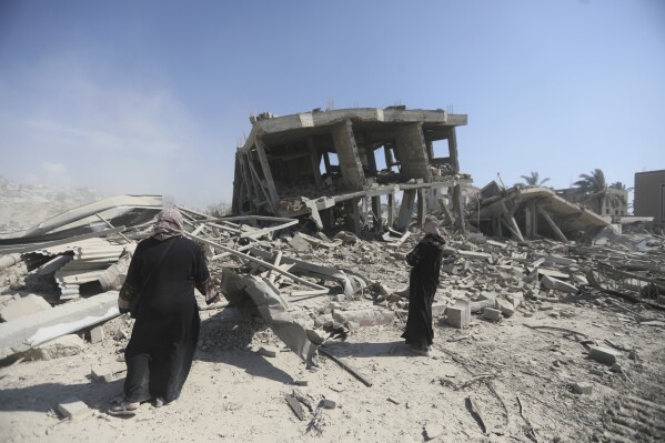 Palestinians inspect the devastation caused by the Israeli air and ground attack after their withdrawal from Khan Yunis, southern Gaza Strip, Sunday, April 7, 2024. (AP Photo/Ismael Abu Dayyah)