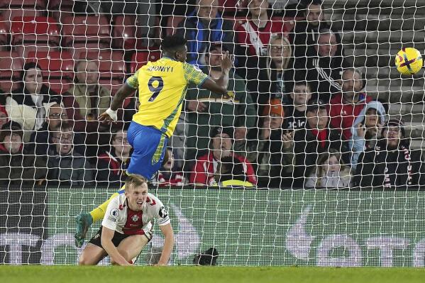 Nottingham Forest's Taiwo Awoniyi scores their side's first goal of the game as Southampton's James Ward-Prowse looks on during the English Premier League soccer match between Southampton and Nottingham Forest at St Mary's Stadium in Southampton, England, Wednesday Jan. 4, 2023. (Adam Davy/PA via AP)
