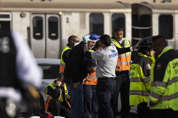 Chicago Fire Department and Chicago Police Department personnel triage patients at the scene after a Chicago Transit Authority train crashed into a piece of equipment that was on the rails near the Howard CTA station on the North Side, Thursday, Nov. 16, 2023 in Chicago. (Ashlee Rezin /Chicago Sun-Times via AP)