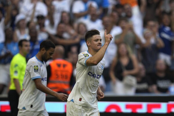 Marseille's Vitor Oliveira Vitinha celebrates after scoring his side's second goal during the French League One soccer match between Marseille and Reims at the Velodrome stadium in Marseille, France, Saturday, Aug. 12, 2023. (AP Photo/Daniel Cole)