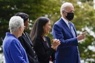 President Joe Biden gestures on the North Lawn of the White House in Washington, Friday, Oct. 8, 2021, with White House national climate adviser Gina McCarthy, Brenda Mallory, chair of the council on environmental quality, and Interior Secretary Deb Haaland during an event announcing that his administration is restoring protections for two sprawling national monuments in Utah that have been at the center of a long-running public lands dispute, and a separate marine conservation area in New England that recently has been used for commercial fishing. (AP Photo/Susan Walsh)