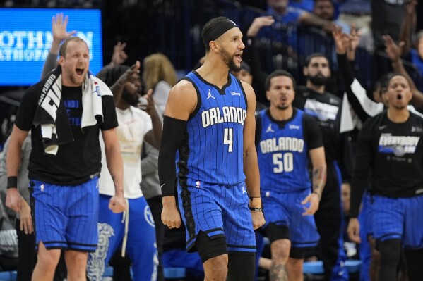 The Orlando Magic bench reacts as guard Jalen Suggs (4) celebrates his 3-point shot against the Cleveland Cavaliers during the first half of Game 3 of an NBA basketball first-round playoff series Thursday, April 25, 2024, in Orlando, Fla. (AP Photo/John Raoux)