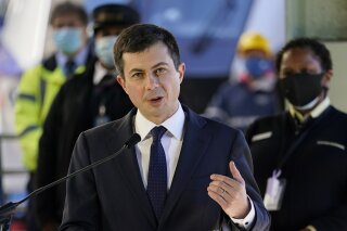 FILE - In this Friday, Feb. 5, 2021 file photo, Transportation Secretary Pete Buttigieg speaks at Union Station in Washington. Airline officials are talking to the Biden administration about support for incentives to use cleaner fuels for airplanes. Leaders of several of the largest U.S. passenger and cargo airlines held an online meeting Friday, Feb. 26, 2021 with White House climate adviser Gina McCarthy and Transportation Secretary Pete Buttigieg.(AP Photo/Carolyn Kaster, File)
